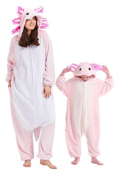 two people dressed in pink and white onesuits, one wearing a pig costume