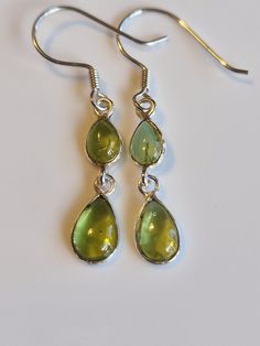 Sterling silver drop peridot  dangle  earrings with AAA green crystals handmade with care.   High quality materials, long-lasting and very sparkly.  Perfect gift for women and girls, makes an ideal stocking filler, Valentine's Day gift, Mother's Day gift, Anniversary gift and birthday gift, these earrings come gift wrapped. Some believe peridot  is derived from the Arabic faridat, meaning "gem," or from the Greek word, peridona, which means "give in abundance." Given its resemblance to the colou Long Green Earrings, Green Teardrop Drop Earrings Nickel Free, Green Nickel-free Teardrop Drop Earrings, Green Nickel-free Teardrop Earrings, Green Teardrop Earrings For Jewelry Making, Green Teardrop Drop Earrings For Jewelry Making, Green And Silver Jewellery, Nickel-free Green Drop Jewelry, Green Drop Jewelry For Jewelry Making