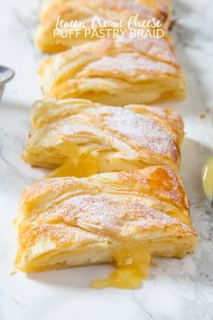 several pieces of pastry sitting on top of a marble counter