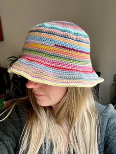 a woman wearing a multicolored crocheted hat