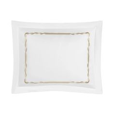 a white pillow with gold trimmings on the edges and an empty square in the middle