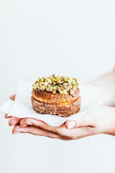 a person holding a pastry in their hands