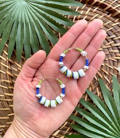 Want to save 15% off your first purchase? Sign up for my email list to receive an instant coupon code! http://eepurl.com/dvS75L This listing is for 35mm gold filled beaded wire hoops featuring blue and white African Sandcast Glass beads, matte cobalt blue and lime green African seed beads, brass spacer beads, and lime green vinyl heishi beads. These earrings are semi-lightweight and should be suitable if you have sensitive ears. If you are not satisfied with your earrings for any reason, please Blue Hoop Earrings With Ear Wire For Beach, Blue Hoop Jewelry For The Beach, Beaded Hoop Jewelry For The Beach, Beaded Hoop Jewelry For Beach, Blue Beaded Hoop Earrings For Summer, Blue Small Hoop Beaded Earrings For Summer, Blue Hoop Earrings For Summer Festivals, Handmade Blue Heishi Beads Earrings, Beach Hoop Earrings With Dangling Beads