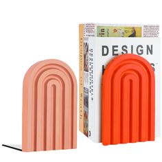 an orange and white object next to a cardboard box with the word design printed on it