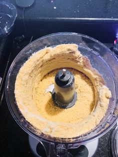 a food processor filled with yellow batter on top of a counter