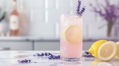 a drink with lemons and lavender on the table