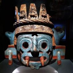 an old mask is on display in a museum