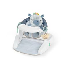 a baby's high chair with a giraffe on the seat and an animal toy