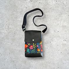 This minimalist crossbody is perfectly compact and is as well suited for a day of errands as it is for travelling.  Beneath a flap that snaps closed you will find the main slip compartment, which keeps essentials like phones, mid-sized wallets, earbuds, and keys handy, as well as a slimmer slip pocket.  The slimmer slip pocket under the flap and the back slip pocket are both ideal for thinner items like card wallets, lip balm, and more.  This features an adjustable crossbody strap which is also removable.   The strap length can be adjusted . DIMENSIONS:   8 1/2" high x 6″ wide x 2″ deep This bag features custom printed faux embroidery floral motif fabric exterior with black vinyl accents, silver hardware, red waterproof lining and a black strap. Minimalist Purse, Faux Embroidery, Bag Minimalist, Crossbody Bags For Women, Embroidery Floral, Purse Crossbody, Tampa Fl, Black Vinyl, Crossbody Purse