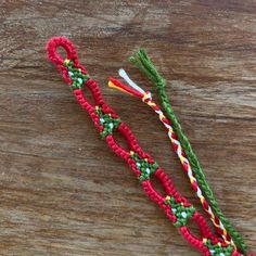 two crocheted toothbrush holders sitting on top of a wooden table