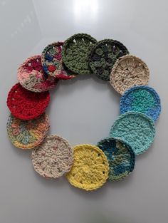 a bunch of crocheted plates sitting on top of a table