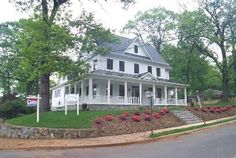 a large white house sitting on the side of a road