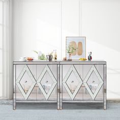 two mirrored sideboards sitting next to each other on top of a carpeted floor