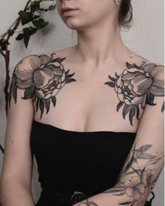 a woman with tattoos on her chest and arm