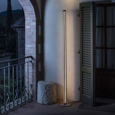 a lamp that is on top of a pole in front of a door and window