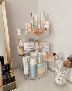 a bathroom counter with cosmetics and other items on it