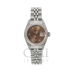 The Rolex Datejust is a timeless icon of elegance and precision. This pre-owned model, reference number 79174, features an automatic movement encased in a 26mm stainless steel case. The bezel, also in stainless steel, frames a striking brown arabic dial, adding a touch of sophistication to its appearance. The scratch-resistant sapphire crystal ensures enduring clarity, protecting the watch face from wear and tear. The watch is complemented by a stainless steel Jubilee bracelet, known for its com Buy Rolex, Seiko Men, Model Reference, Watch Faces, Rolex Datejust, Stainless Steel Watch, Sapphire Crystal, Stainless Steel Bracelet, Quartz Watch