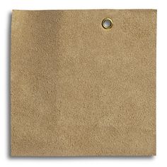 a brown piece of paper with a hole in the middle and a ring on it