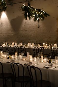 a long table is set up with candles and place settings for dinner guests to enjoy