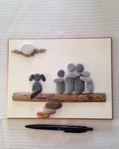 some pebbles are sitting on a piece of wood