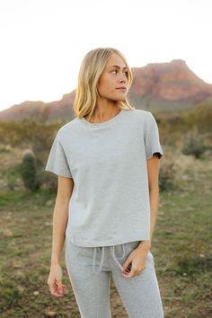 THIS SALE ITEM IS FINAL SALE! The Kellie Set-Heather Grey is the perfect combination of comfort and style! This set includes a relaxed fit short sleeve top and elastic waist jogger-style sweatpants, both in a cozy heather grey. Stay comfy and fashionable all day long! *Relaxed fit* Material Content: 100% Cotton // Bottoms: 65% Cotton // 35% Polyester Material Pattern: Heather Avery is 5'6" and wearing a small Model Measurements: Avery: Height: 5'6" // Chest: 31” // Waist: 24" // Hips: 31" Not su Short Sleeve Tops With Elastic Waistband For Loungewear, Comfy Short Sleeve Tops For Spring, Comfy Short Sleeve Spring Tops, Leisure Tops With Elastic Waistband For Spring, Spring Leisure Tops With Elastic Waistband, Casual Tops With Elastic Waistband, Athleisure Solid Top With Elastic Waistband, Athleisure Top With Elastic Waistband, Sporty Top With Elastic Waistband And Relaxed Fit