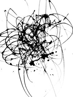 black ink splattered on white paper with an abstract design in the middle and bottom corner