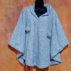 This Is A Hooded Poncho Or Cape. It Is A Fluffy Light Gray Material. The Hood Is A Cute Sleeping Owl Face With Ears. There Are Balls Hanging From Each Side Of The Strings. This Is A Plus Size One Size Fits All, But I Believe It Would Also Fit Smaller Sizes As Well. This Is New With Tags. Casual One Size Cape For Cold Weather, Casual One-size Cape For Winter, Casual One-size Cape For Cold Weather, Cozy Solid Poncho For Winter, Cozy Poncho For Winter, Casual Hooded Poncho For Cold Weather, Casual Hooded Winter Cape, Hooded Winter Poncho One Size, Winter Hooded Poncho One Size