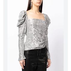 The Allura Hammered Sequin Top In Silver. Romantic Puffed Sleeves Frame This Square Neck Top, Immersed In Highly Reflective Hammered Sequins. Gentle Ruching And An Asymmetric Hem Modernize The Shape For Directional Styling. Size 2 And New With Tags. Retail $495. Concealed Side Zipper Self: 91% Polyester 9% Spandex Lining: 100% Polyester Bust - 14" Armpit To Armpit Length - 22" Shoulder To Hem Glamorous Fitted Blouse With Blouson Sleeves, Fitted Blouson Sleeve Party Tops, Ruched Puff Sleeve Blouse For Party, Puff Sleeve Ruched Blouse For Parties, Party Ruched Puff Sleeve Blouse, Party Blouse With Ruched Puff Sleeve, Fitted Tops With Gathered Sleeves For Parties, Fitted Blouson Sleeve Party Blouse, Party Fitted Puff Sleeve Top With Gathered Sleeves