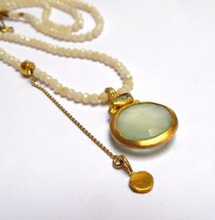 Chalcedony and Aquamarine - Beautiful Chalcedony and Aquamarine, wrapped with 24k solid gold. 24k gold dot, 24k gold beads, 18k chain. Moonstone 2mm beads Necklace ,42cm length. The Chalcedony stone size is 14mm. The Aquamarine stone size is 5/3mm. Free Shipping Your necklace will be shipped via registered air mail with tracking number. The Necklace will be packed in a Beautiful gift box. Please contact me with any questions or requests. 2mm Beads, Gold Dot, Chalcedony Stone, Aquamarine Pendant, Gold Dots, Aquamarine Stone, Moonstone Necklace, Pendant Gold, Beads Necklace