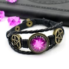 This black faux leather bracelet features a purple wiccan magic circle. The metal parts are made from electroplated zinc alloy while the featured magic circle is made from curved glass. The total length of the bracelet is 215mm and it is adjustable between two sizes (175mm and 195mm). International Shipping - Registered Airmail Once you have made your purchase please allow for 3-4 business days for us to package and ship your item. Once it is shipped you will receive a tracking number with China Magic Bracelet, Faux Leather Bracelets, Wiccan Magic, Dark Magic, Circle Bracelet, Magic Circle, Curved Glass, Wedding Jewelry Bracelets, Wax Stamp