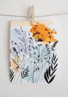 a piece of paper hanging from a clothes line with flowers and bees painted on it