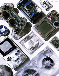 several electronic devices are arranged on a table top, including a game controller and other electronics