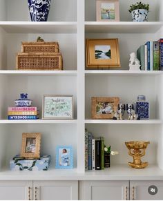 the shelves are filled with books and vases