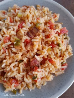 a white plate topped with rice and vegetables