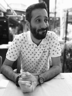 a man with a beard sitting at a table