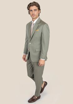 Elevate your style game with the Verona Sage Twill Suit. Crafted from luxurious merino wool by Vitale Barberis Canonico, Italy, this custom-made suit exudes elegance and makes a bold statement wherever you go. Its sleek design and eye-catching color will surely turn heads and inspire you to take on new challenges with confidence. Elegant Green Slim Fit Suits, Elegant Green Business Sets, Elegant Wool Sets For Workwear, Custom Fit Notch Lapel Sets For Business Casual, Semi-formal Custom Fit Set With Notch Lapel, Tailored Wool Sets For Workwear, Luxury Single Breasted Workwear Set, Custom Fit Notch Lapel Set For Semi-formal Occasion, Luxury Fitted Sets For Workwear