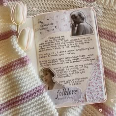 an open book with pictures on it next to a knitted scarf and flower headband