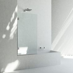 a bathroom with a sink, mirror and shower head mounted to the side of the wall