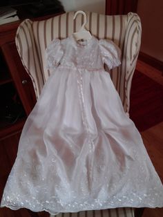 Beautiful embroidered organza gown. Bodice has the same embroidery along with delicate daisy like flower with a pearl center along neckline and waist. It has button back. Matching bonnet also has embroidery and ruffled edging with same flowers along the ruffled edge. Made to fit 3 to 6 mos. Finished dress is 32 inches from shoulder to hem. Soft cotton batiste lines dress and bonnet. Floral Applique Ball Gown With Fitted Bodice, Fitted Embroidered Ball Gown, Fitted Embroidered Dress For Baptism, Embroidered Fitted Dress For Baptism, Organza Ball Gown With Floral Applique, Organza Gown With Floral Applique And Fitted Bodice, Organza Gown With Floral Embroidery And Fitted Bodice, Formal Organza Gown With Floral Embroidery, Fitted Embroidered Dress For First Communion