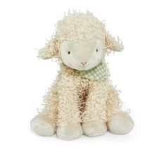 a white stuffed sheep with a green checkered collar sitting on a white background and looking at the camera