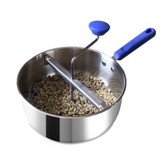 a large metal bowl filled with lots of food and a blue spatula in it