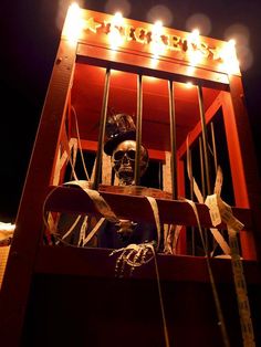 a wooden crate with a skeleton in it and some lights on the top of it