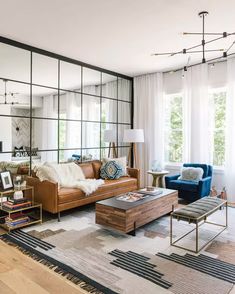 a living room filled with furniture and lots of windows