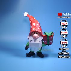 an origami christmas gnome holding a gift box on a blue background with words below