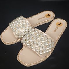 Nwt Bebe "Shirin", Size 7 Pearl And Silver Bead Embellished Toe Strap Rhinestones Surround Outer Edge Of Footbed Synthetic Sole And Upper Glamorous White Embellished Sandals, Embellished White Synthetic Sandals, Elegant Beaded Synthetic Sandals, Pearl Sandals For Summer Party, White Flat Embellished Sandals, White Embellished Flat Sandals, Summer Party Pearl Sandals, Elegant White Beaded Sandals, Rhinestone Slides