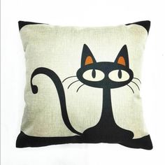 a black and white pillow with a cat on it