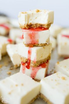 four pieces of cheesecake stacked on top of each other with strawberries in the middle