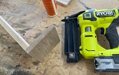 a cordless drill and some tools on a table