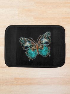 a bath mat with a blue butterfly on it