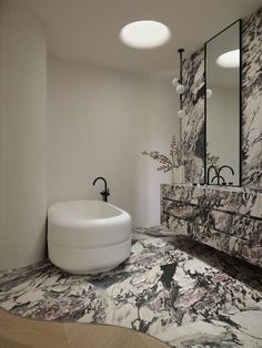 a bathroom with marbled flooring and large mirror on the wall next to it